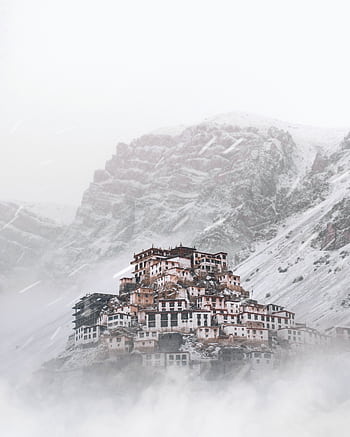 Key Monastery enveloped in winter snow in the serene Himalayas. A misty, cold landscape of beauty and tranquility. HD phone wallpaper