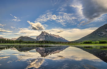 Serene landscape of Banff National Park with mountains and lake reflections at sunrise. HD wallpaper