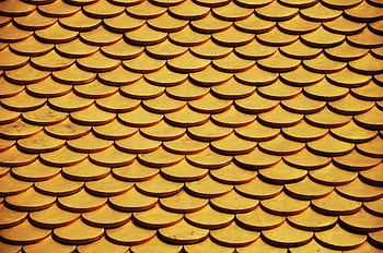 Close-up of a golden scaled roof pattern, ideal for design backgrounds or . HD wallpaper