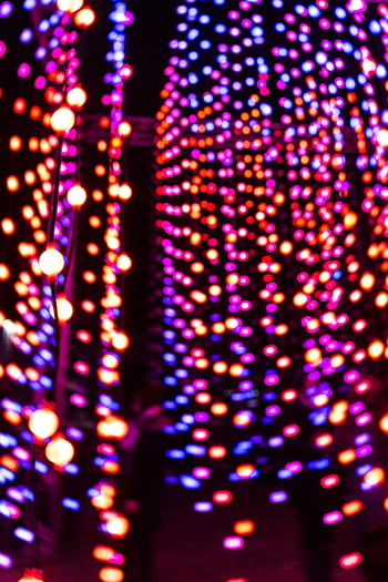 Colorful defocused lights creating a vibrant abstract bokeh effect in a night setting. HD phone wallpaper