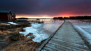 pier on a frozen lake at sunset, frozen, boat house, pier, grass, lake, sunset HD wallpaper