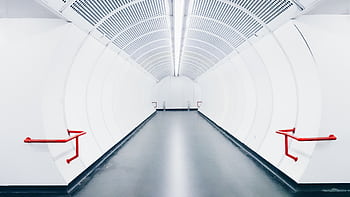 Modern underground white tunnel with red handrails and futuristic design. HD wallpaper