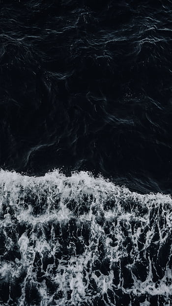 A breathtaking aerial shot of powerful waves in a dark ocean, showcasing nature's energy and majesty. HD phone wallpaper