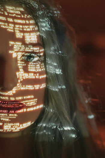 Abstract cyberpunk portrait with code projected on a woman's half face, symbolizing technology integration. HD phone wallpaper