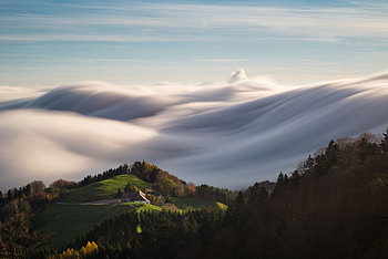 A home sitting atop a lush mountain encircled by soft-serve clouds, horizon, white, beautiful, mountain home, mountain, fog, foggy, green, trees, clouds, sky, mountains, home, cloud HD wallpaper