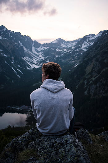A person enjoying a serene mountain view at twilight, embracing solitude and adventure. HD phone wallpaper
