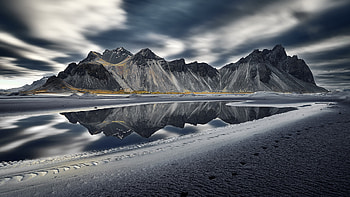 Black Rock Mountains Sand Under White Black Clouds Sky Reflection On Water Mountain HD wallpaper