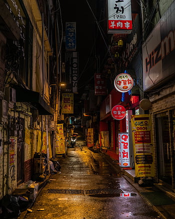 Explore the lively, narrow alleyways of Seoul at night with bright signage and bustling nightlife. HD phone wallpaper