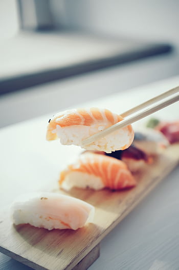 Artistic close-up of a sushi piece with salmon, depicting fresh and appetizing Asian cuisine. HD phone wallpaper