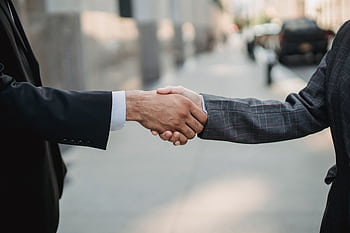Close-up of a business handshake between professionals outdoors. HD wallpaper