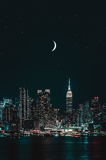 Stunning night view of New York City skyline with a crescent moon and stars illuminating the scene. HD phone wallpaper