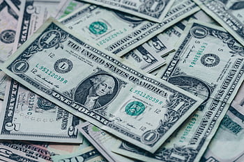 Close-up of stacked US dollar bills representing wealth and finance. HD wallpaper