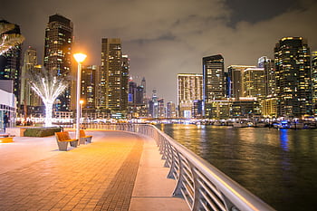 Beautiful night view of Dubai Marina, showcasing the stunning illuminated skyline and waterfront promenade. HD wallpaper