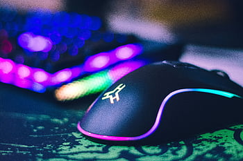 A close-up of a colorful gaming mouse and illuminated RGB keyboard, perfect for tech setups. HD wallpaper