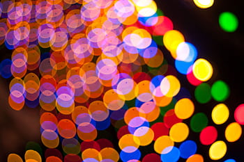 Colorful circular bokeh lights create a festive and abstract pattern with vibrant colors. HD wallpaper