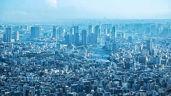 A breathtaking aerial view of Tokyo's urban landscape with prominent skyscrapers under clear skies. HD wallpaper