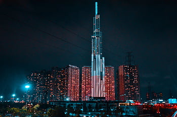 Captivating view of Ho Chi Minh City's skyline illuminated at night, showcasing the Landmark 81 tower. HD wallpaper