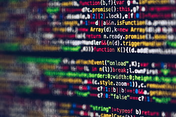 Vivid, blurred close-up of colorful code on a screen, representing web development and programming. HD wallpaper