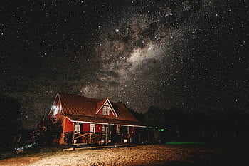 A beautiful starry night sky with the Milky Way over a rustic house, perfect for astronomy lovers. HD wallpaper