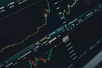 Close-up of stock market trading screen displaying financial growth and charts. HD wallpaper