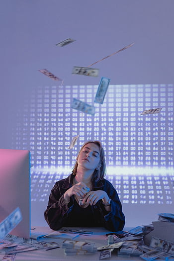 Confident woman with cash and data projections, representing financial wealth and technology. HD phone wallpaper
