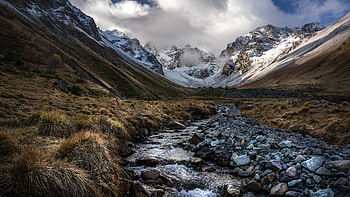 Landscape View Of Snow Covered Mountains With Fog Dry Bushes Grass Water Stream Stones Nature HD wallpaper