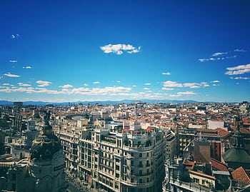 A breathtaking aerial view of Madrid's vibrant cityscape under a clear blue sky. HD wallpaper