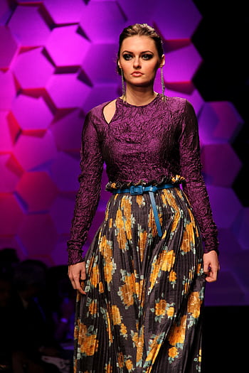 Elegant model on a fashion runway, showcasing a stylish floral patterned dress under vibrant lighting. HD phone wallpaper
