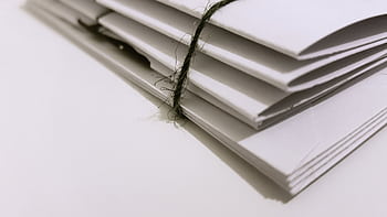 Pile of white envelopes tied with a green string, showcasing a minimalist design. HD wallpaper
