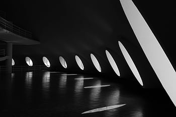 Black and white interior view of a modern architectural space in São Paulo with unique lighting design. HD wallpaper
