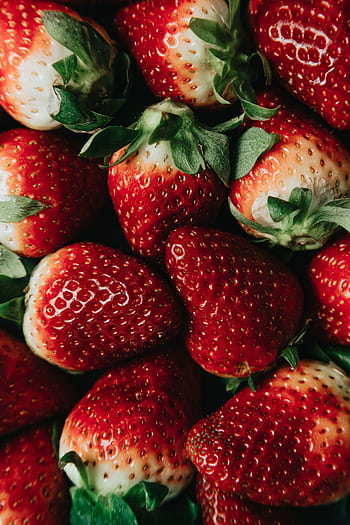Vibrant close-up showcasing fresh ripe strawberries, highlighting their rich color and juicy texture. HD phone wallpaper