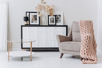 A cozy, contemporary interior setup with a beige chair, soft decor, and elegant furnishings. HD wallpaper