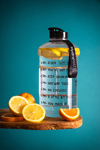 Lemon-infused water bottle with motivational text, perfect for hydration goals. HD phone wallpaper