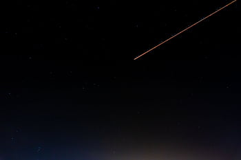 A serene night sky with a shooting star and numerous stars over Kénitra, Morocco. HD wallpaper
