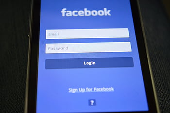 Close-up of a smart screen showing the Facebook login interface. HD wallpaper