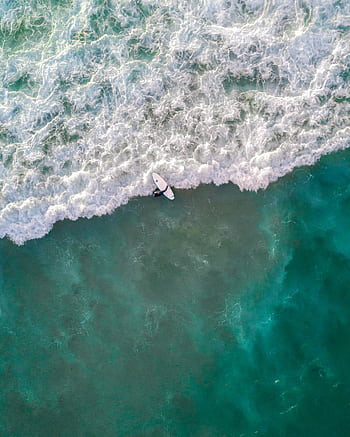 Captivating aerial shot of a surfer riding waves at Bondi Beach, Australia. HD phone wallpaper