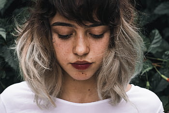 Close-up portrait of a young woman with freckles and two-toned hair outdoors. HD wallpaper
