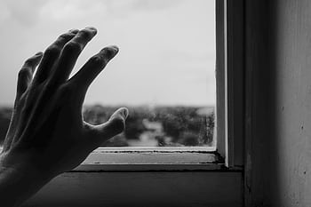 Abstract monochrome of a hand reaching towards a window, symbolizing longing. HD wallpaper