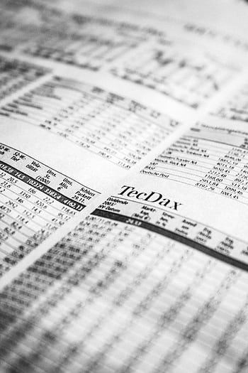 Close-up of a printed stock market report in black and white, highlighting stock prices. HD phone wallpaper