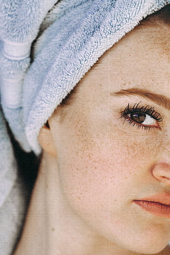 Close-up portrait of a woman with a towel turban and fresh freckled skin. HD phone wallpaper