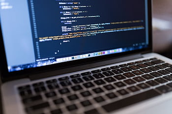 Focused view of programming code displayed on a laptop, ideal for tech and coding themes. HD wallpaper