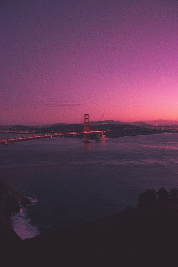 Dramatic view of Golden Gate Bridge under a vivid purple sky at dusk. HD phone wallpaper