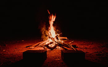 A warm campfire burning brightly against the dark night in Pedra Bela, Brazil. HD wallpaper