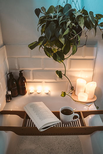 Relax in a cozy bathtub with candles, tea, and a book for a serene evening. HD phone wallpaper