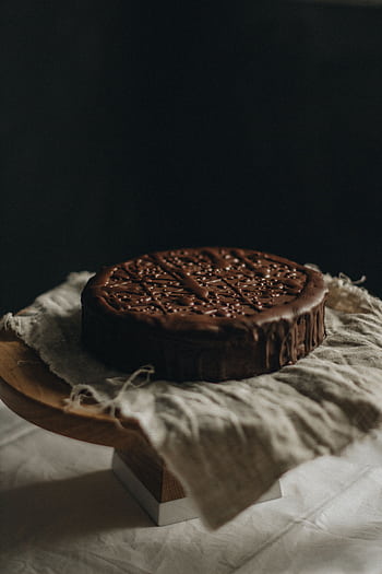 Delicious chocolate cake placed on rustic linen, ideal for dessert graphy. HD phone wallpaper