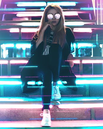 A fashionable woman sits on neon-lit stairs at night, wearing reflective sunglasses and trendy attire. HD phone wallpaper
