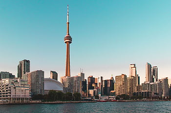 Beautiful view of Toronto's skyline featuring the iconic CN Tower during sunset. HD wallpaper