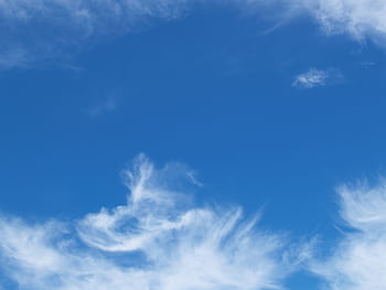 Clear blue sky with soft, fluffy white clouds forming beautiful patterns. HD wallpaper