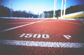 Empty running track lane with 1500 meter marking, sunny day outdoors. HD wallpaper