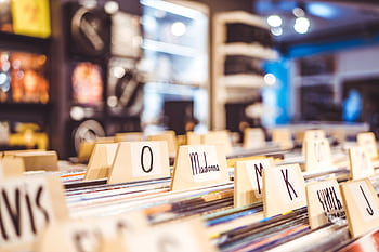 Close-up of vinyl records organized alphabetically in a music store. HD wallpaper